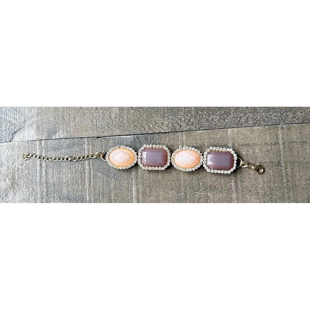 Gold tone bracelet with purple and pink square gems 10"